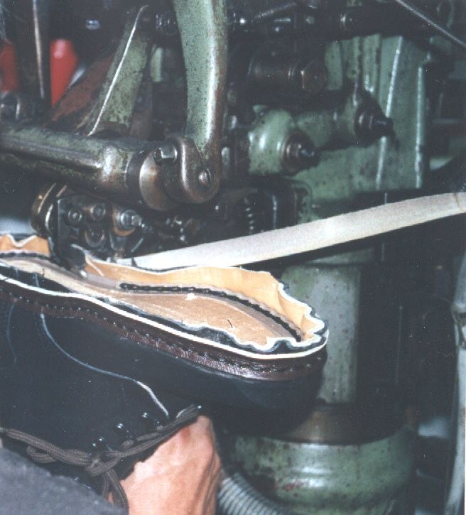 Herstellung: der Rahmennaht durch Vernähen des Oberteils mit der Brand-, der Laufsohle und des Einstechrahmens